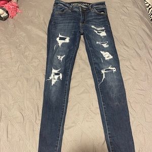 American Eagle jeans with patches underneath the holes